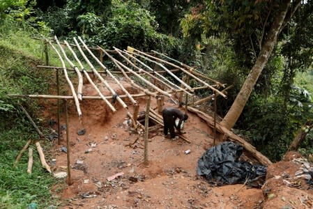 An artisanal gold miner works at the unlicensed mining site of Nsuaem Top in Ghana