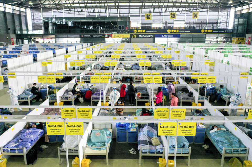 In this photo released by China's Xinhua News Agency, people with mild and asymptomatic cases of COVID-19 quarantine at the Shanghai New International Expo Center in Shanghai, Friday, April 1, 2022. In Shanghai to the north, authorities are struggling to meet requirements for a lockdown on many of the city’s 26 million residents — the largest such undertaking by China since the virus was first detected in the central city of Wuhan in late 2019.(Ding Ting/Xinhua via AP)