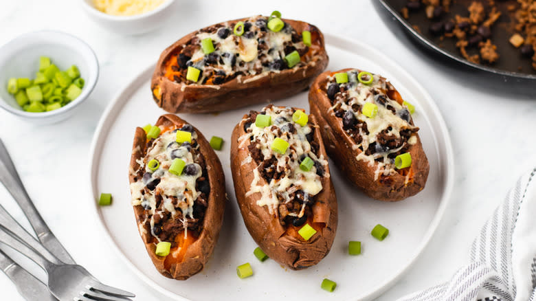 cheesy beef-stuffed sweet potatoes on plate