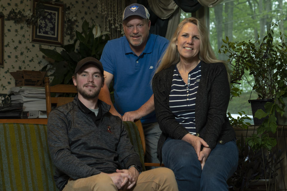 TeriAnn Reynolds right, poses for a portrait with her former husband John Reynolds and son Matthew Reynolds, Thursday, April 27, 2023, in Johnson City, Tenn. The Reynolds hosted over 40 minor league baseball players from the Johnson City Cardinals in their home for more than 10 years. (AP Photo/George Walker IV)