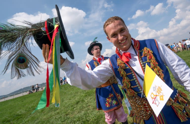 People in traditional outfits wait for the arrival of Pope Francis at the John Paul II International airport in Krakow-Balice, on July 27, 2016