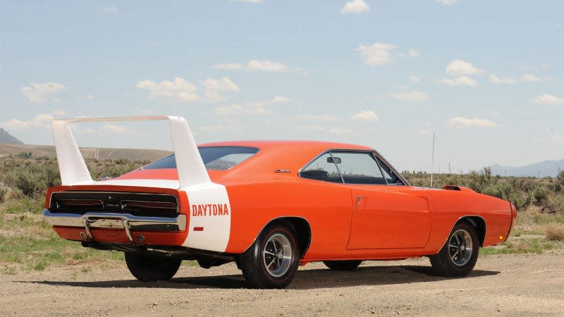 A photo of an orange Dodge Charger Daytona with a large rear wing. 