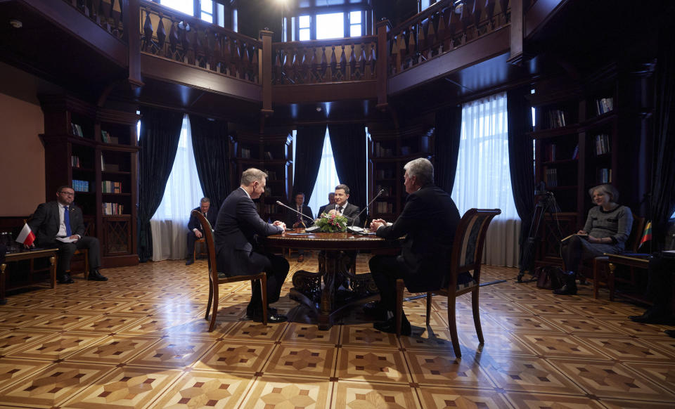 Ukrainian President Volodymyr Zelenskyy, center, Poland's President Andrzej Duda, left, and Lithuania's President Gitanas Nauseda during their meeting at the presidential residence in Ivano-Frankivsk region, 430 kilometers (270 miles) southwest of the capital, Kyiv, Monday, Dec. 20, 2021. (Ukrainian Presidential Press Office via AP)