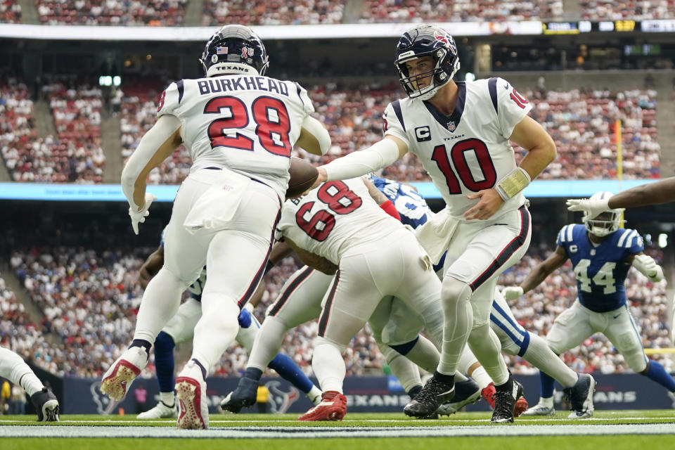 Houston Texans quarterback Davis Mills (10) hands off to running back Rex Burkhead (28) during the second half of an NFL football game Sunday, Sept. 11, 2022, in Houston. (AP Photo/Eric Christian Smith)