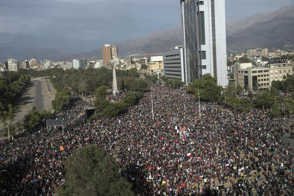 People gather for an anti-government protest in Santiago, Chile, Friday, Nov. 1, 2019. Groups of Chileans continued to demonstrate as government and opposition leaders debate the response to nearly two weeks of protests that have paralyzed much of the capital and forced the cancellation of two major international summits.(AP Photo/Rodrigo Abd)