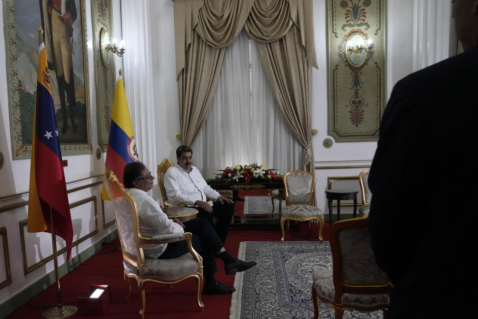 Colombia's President Gustavo Petro, left, and Venezuelan President Nicolas Maduro, sit inside the Miraflores Presidential Palace before the start of their private meeting, in Caracas, Venezuela, Tuesday, Nov. 1, 2022. (AP Photo/Ariana Cubillos)