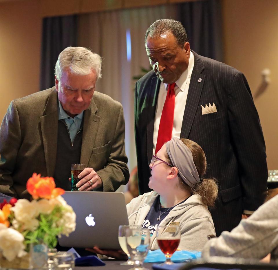 Akron mayoral candidate Marco Sommerville, right, and retired Akron Children's Hospital CEO Bill Considine take a peek over a supporter's shoulder for an update on results at watch party at the Hilton Garden Inn Tuesday in Akron.