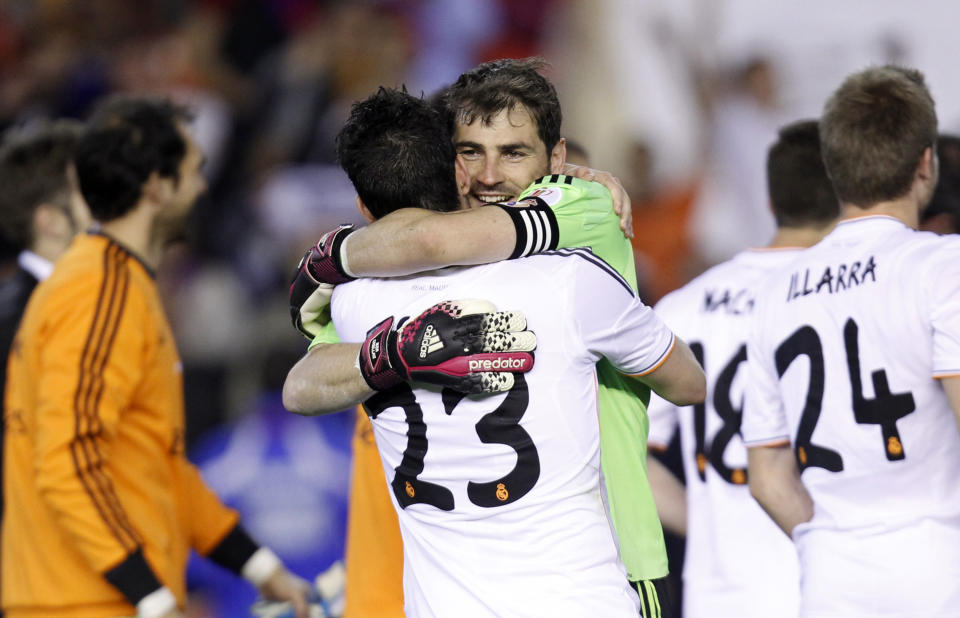 Real's goalkeeper Iker Casillas, centre rear hugs Isco after Real Madrid won the final of the Copa del Rey between FC Barcelona and Real Madrid at the Mestalla stadium in Valencia, Spain, Wednesday, April 16, 2014. (AP Photo/Alberto Saiz)