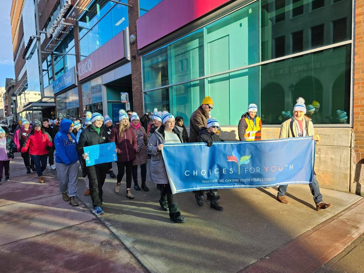 As many as 300 people marched the streets of Downtown St. John's, starting from Atlantic Place and walking for an hour to represent the daily struggles faced by those without shelter and to raise awareness. (Arlette Lazarenko/CBC - image credit)