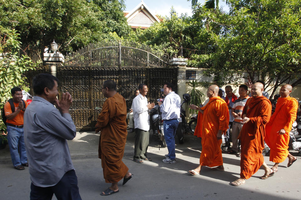 Cambodian Buddhist monks arrive in front of the house of Kem Sokha, former leader of now dissolved opposition Cambodia National Rescue Party, in Phnom Penh, Cambodia, Monday, Sept. 10, 2018. Kem Sokha was released on bail Monday after being jailed for a year on a treason charge, a government spokesman said. A small crowd has gathered outside his home in Phnom Penh but so far he hasn’t been seen. His whereabouts are, as yet, unclear. (AP Photo/Heng Sinith)