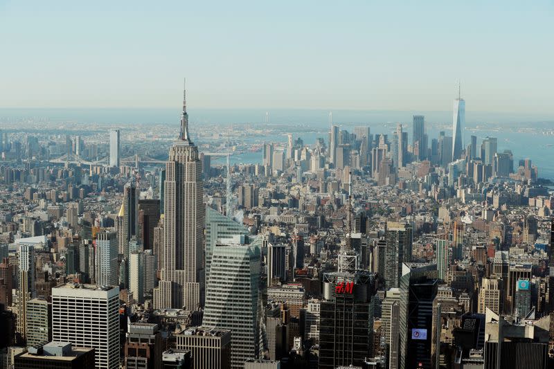 The Empire State Building and One World Trade Center rise above Manhattan as seen from an apartment in the Central Park Tower building as the building celebrates its topping out in New York