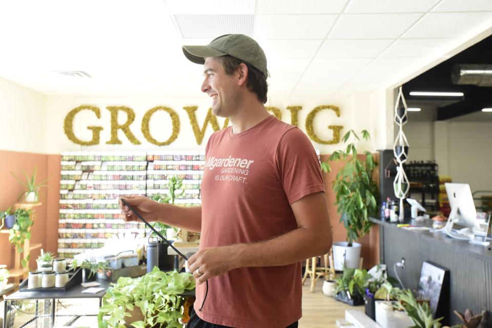 MIGardener owner Luke Marion smiles during an interview inside the newly renovated MIGardener store in St. Clair on Friday, July 22, 2022.