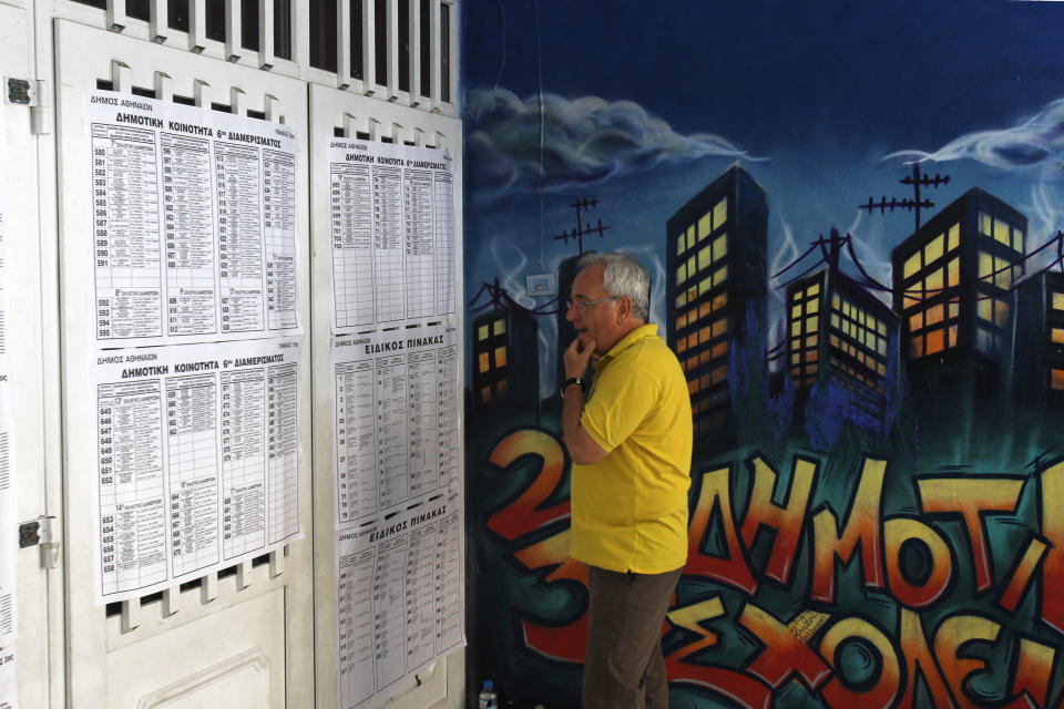 A Greek man checks the voting lists at a center voting during the elections in Athens, Sunday, June 17, 2012. Greeks voted Sunday for the second time in six weeks in what was arguably their country's most critical election in 40 years, with the country's treasured place within the European Union's joint currency in the balance. (AP Photo/Petros Karadjias)