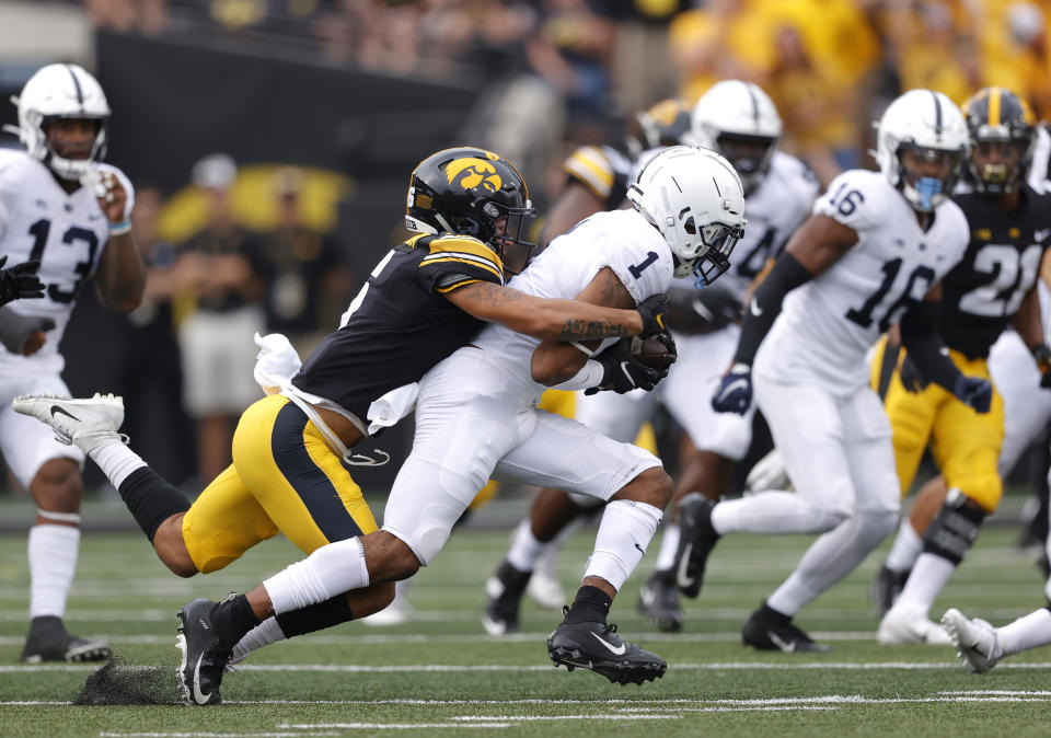 Penn State safety Jaquan Brisker (1) runs back an interception as Iowa wide receiver Keagan Johnson (6) makes the tackle during the first half of an NCAA college football game, Saturday, Oct. 9, 2021, in Iowa City, Iowa. (AP Photo/Matthew Putney)