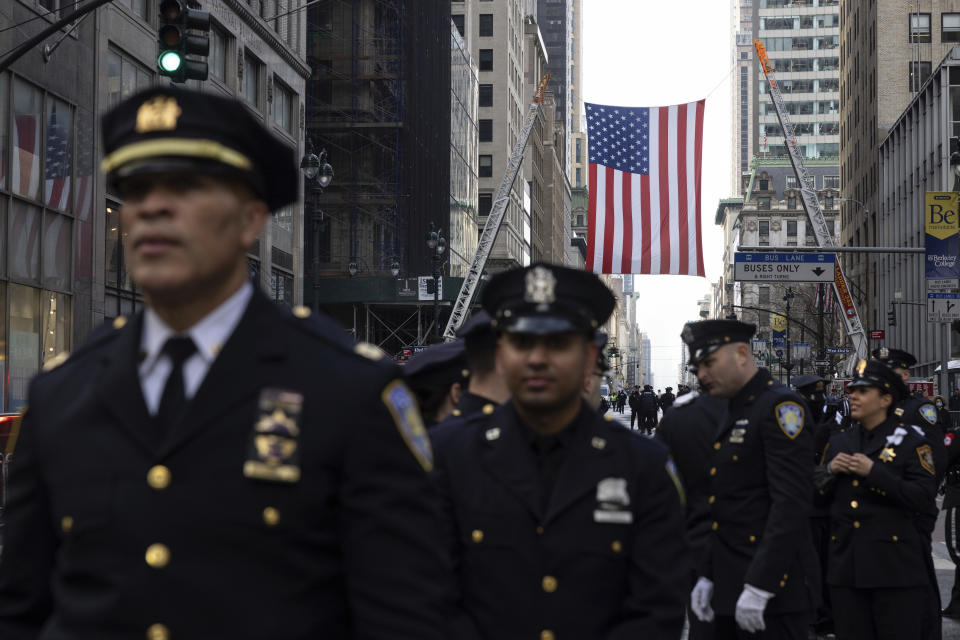 New York Police officers gather along Fifth Avenue outside St. Patrick's Cathedral for Officer Wilbert Mora's funeral, Wednesday, Feb. 2, 2022, in New York. Mora was shot along with Officer Jason Rivera on Jan. 22 while responding to a call about a domestic argument in an apartment. (AP Photo/Yuki Iwamura)