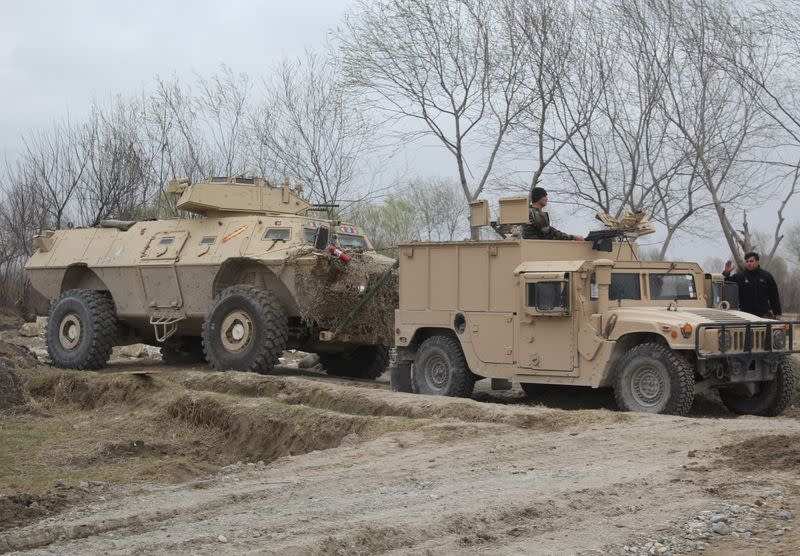 Afghan National Army (ANA) soldiers arrive at the site of last night clashes between Taliban and Afghan forces in Kunduz, Afghanistan