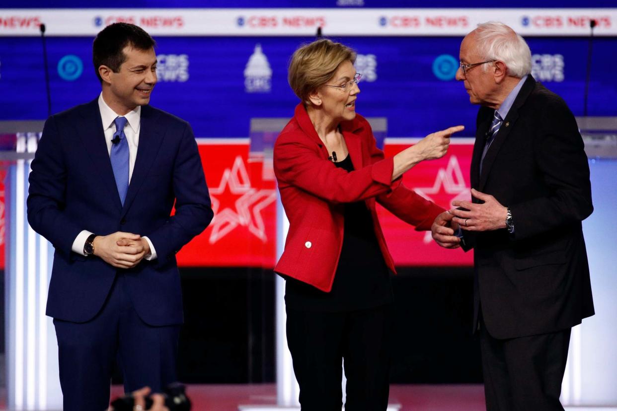 Clash: Pete Buttigieg, Elizabeth Warren and Bernie Sanders on stage after the debate in South Carolina: AP