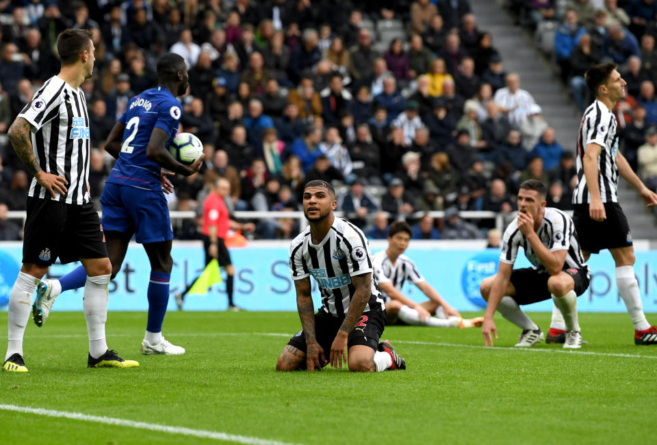 DeAndre Yedlin, center, sits in disbelief after his own goal helped Chelsea beat Newcastle. (Getty)
