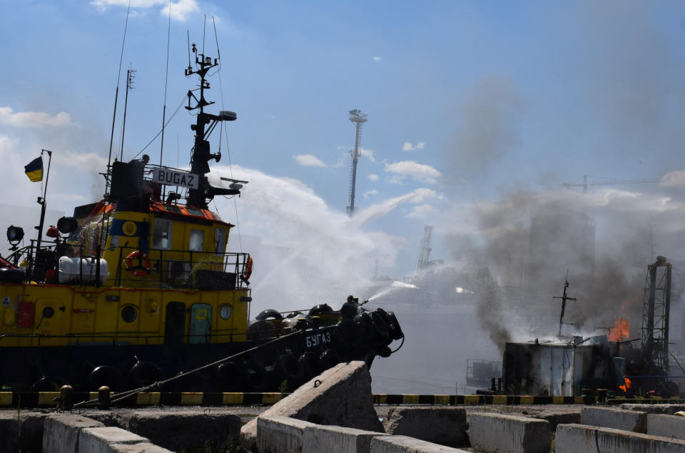 Firefighters work at a site of a Russian missile strike in a sea port of Odesa, as Russia's attack on Ukraine continues, Ukraine July 23, 2022.  Press service of the Joint Forces of the South Defence/Handout via REUTERS ATTENTION EDITORS - THIS IMAGE HAS BEEN SUPPLIED BY A THIRD PARTY.