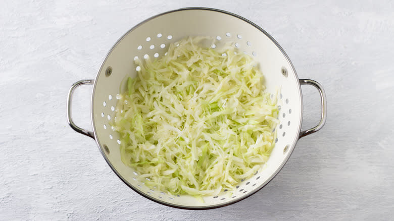 shredded cabbage in colander