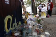 People pay tribute as they attend a peace walk honoring the life of police shooting victim 13-year-old Adam Toledo, Sunday, April 18, 2021, in Chicago's Little Village neighborhood. (AP Photo/Shafkat Anowar)