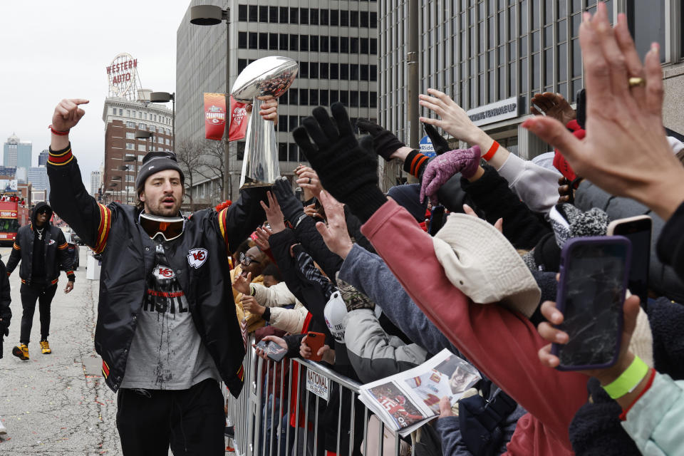 Kansas City Chiefs tight end Noah Gray celebrates with fans during the NFL football team's victory celebration and parade in Kansas City, Mo., Wednesday, Feb. 15, 2023, following the Chiefs' win over the Philadelphia Eagles Sunday in the NFL Super Bowl 57 football game. (AP Photo/Colin E. Braley)