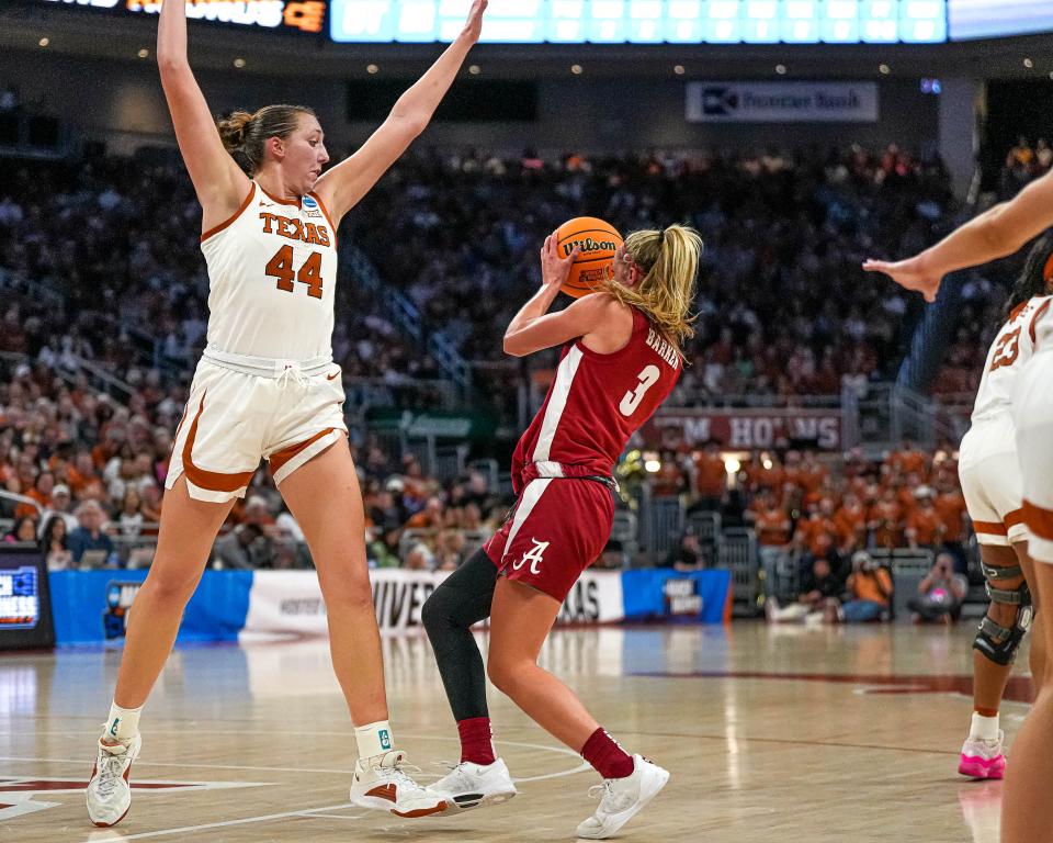 Texas forward Taylor Jones guards Alabama guard Sarah Ashlee Barker during Sunday's game. Jones stands 6-foot-4; Barker is 6-feet. "They're so big," Alabama coach Kristy Curry said about the Longhorns. "They just run waves at you at the four and five spots."