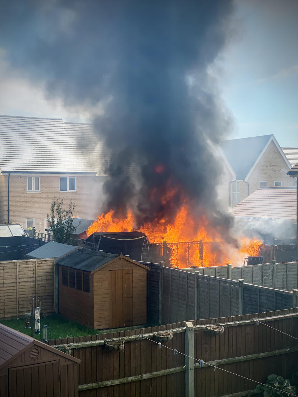 A freak fire left three families homeless after a shard of glass reflected onto a wooden fence (SWNS)