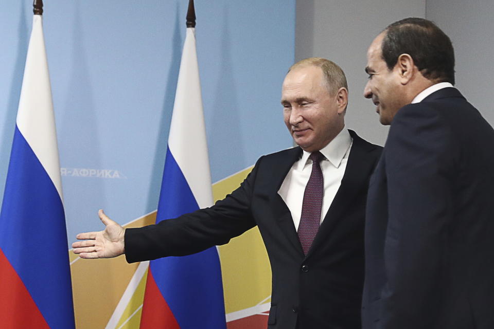 Russian President Vladimir Putin, left, welcomes Egypt's President Abdel Fattah el-Sisi during their meeting in the Black Sea resort of Sochi, Russia, Wednesday, Oct. 23, 2019. (Sergei Fadeyechev, TASS News Agency Pool Photo via AP)