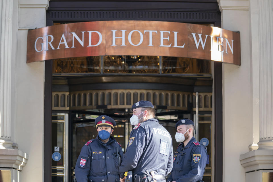 Police officers stay in front of the 'Grand Hotel Wien' in Vienna, Austria, Friday, April 9, 2021 where closed-door nuclear talks with Iran take place. Diplomats meeting in Vienna assess progress of three days of talks aimed at bringing the United States back into the nuclear deal with Iran. (AP Photo/Florian Schroetter)