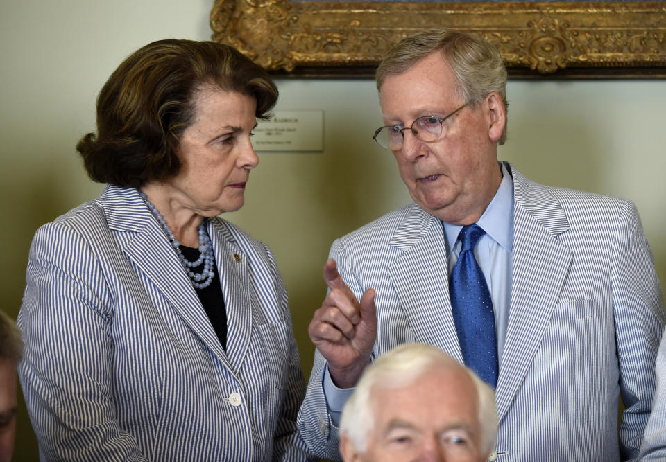 FILE - U.S. Sen. Dianne Feinstein, D-Calif., talks with Senate Majority Leader Mitch McConnell, of Ky., on Capitol Hill in Washington, Thursday, June 11, 2015, before a group photo of senators for National Seersucker Day. (AP Photo/Susan Walsh, File)