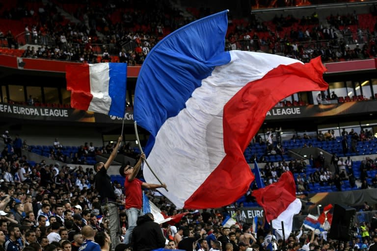 Supporters wave French flags prior to the UEFA Europa League first leg quarter final football match between Lyon (OL) and Besiktas on April 13, 2017, at the Parc Olympique Lyonnais stadium in Decines-Charpieu