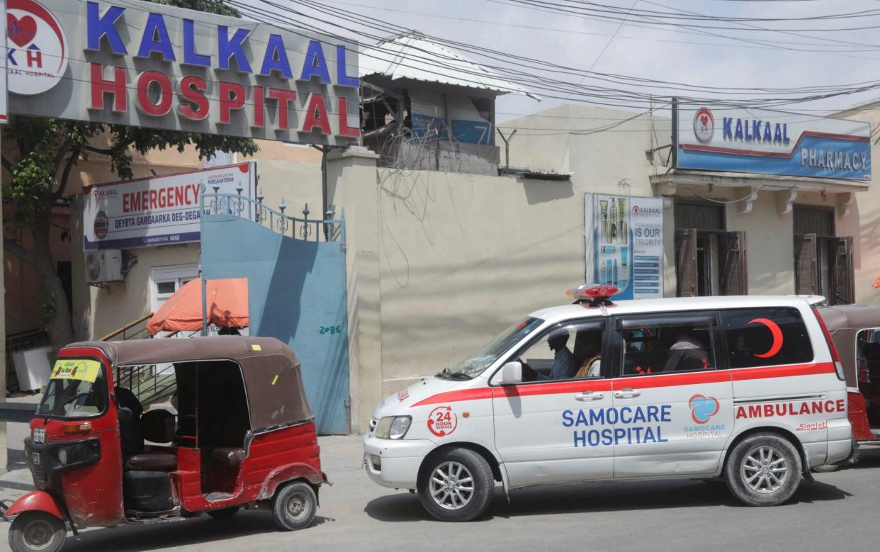 An ambulance carrying a wounded person drives into Kalkaal hospital after militants attacked the Villa Rose Hotel - Feisal Omar/Reuters