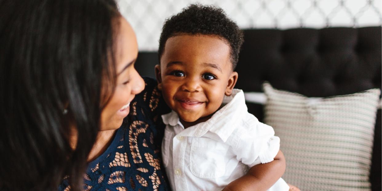 mom holding son and laughing with him - raising a son