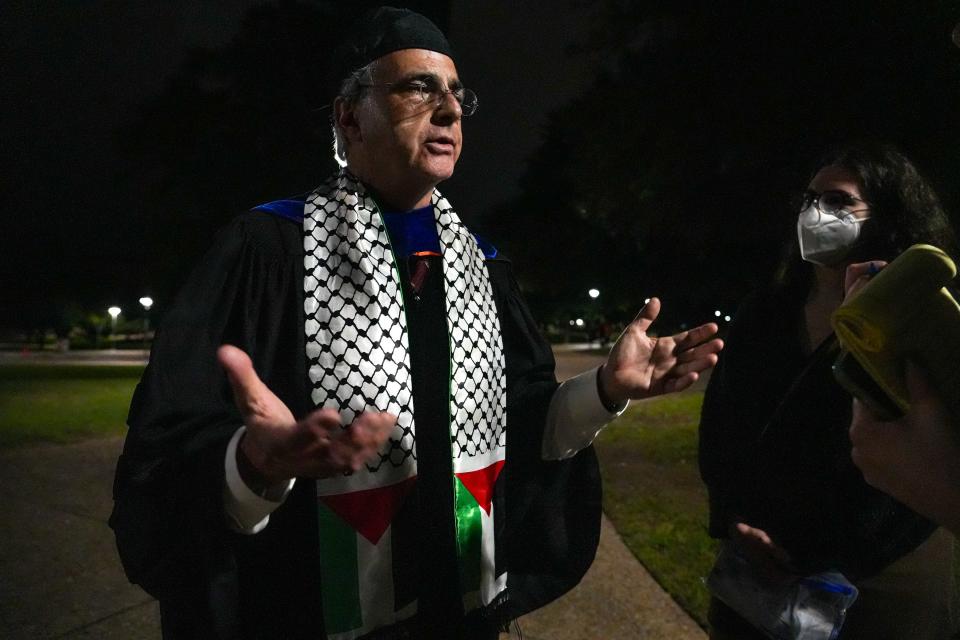 Paul Shapiro, a UT astronomy professor, wears a stole featuring Palestinian flags after the graduation ceremony Saturday night. Shapiro spontaneously attended a post-commencement protest of about 100 people. Protesters are calling for UT to divest from interests supporting Israel's war against Hamas in Gaza.