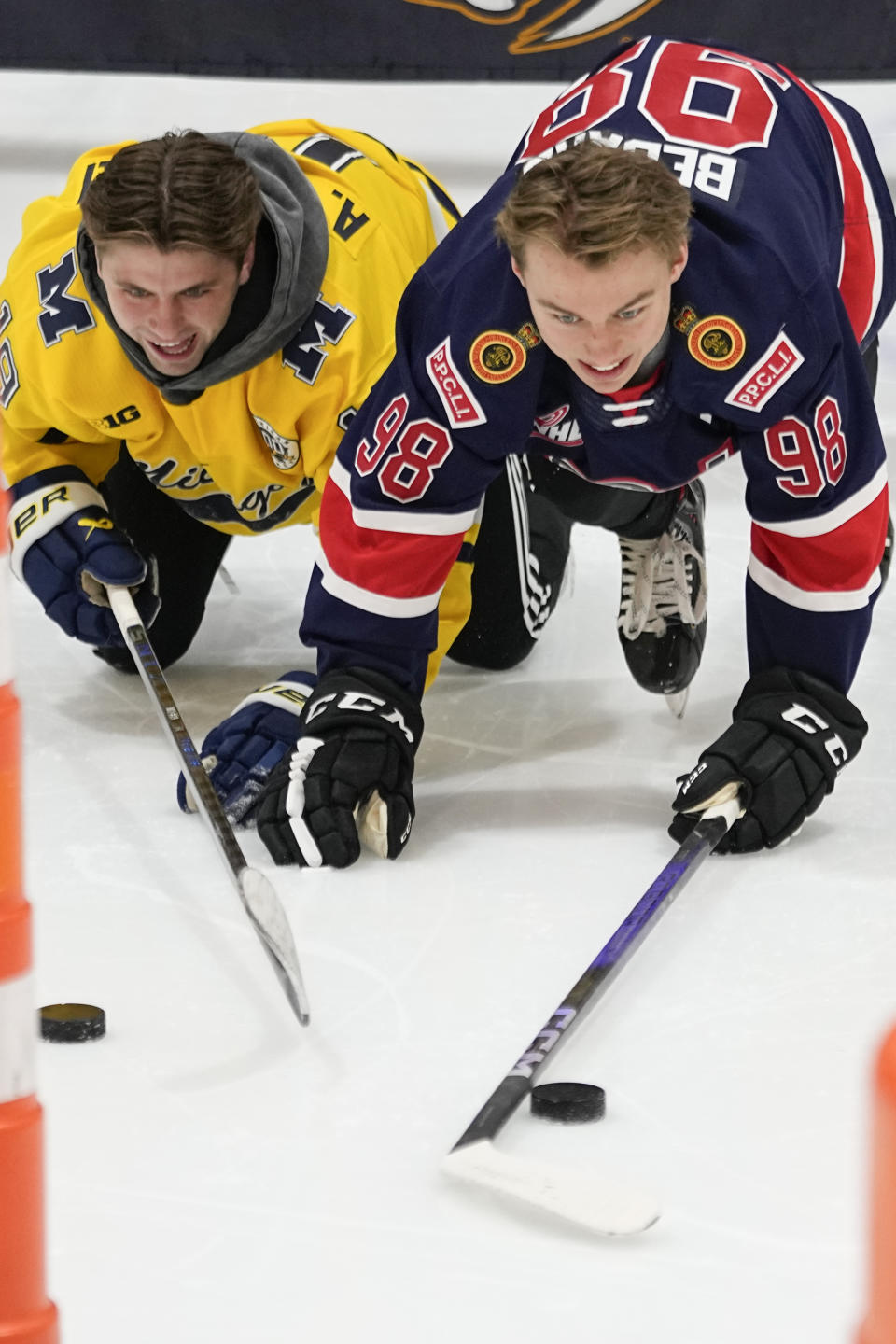 NHL draft prospects Adam Fantilli, left, and Connor Bedard, right, slide across the ice during a youth hockey clinic with other draft prospects and members of the NHL Player Inclusion Coalition, Tuesday, June 27, 2023, in Nashville, Tenn. (AP Photo/George Walker IV)
