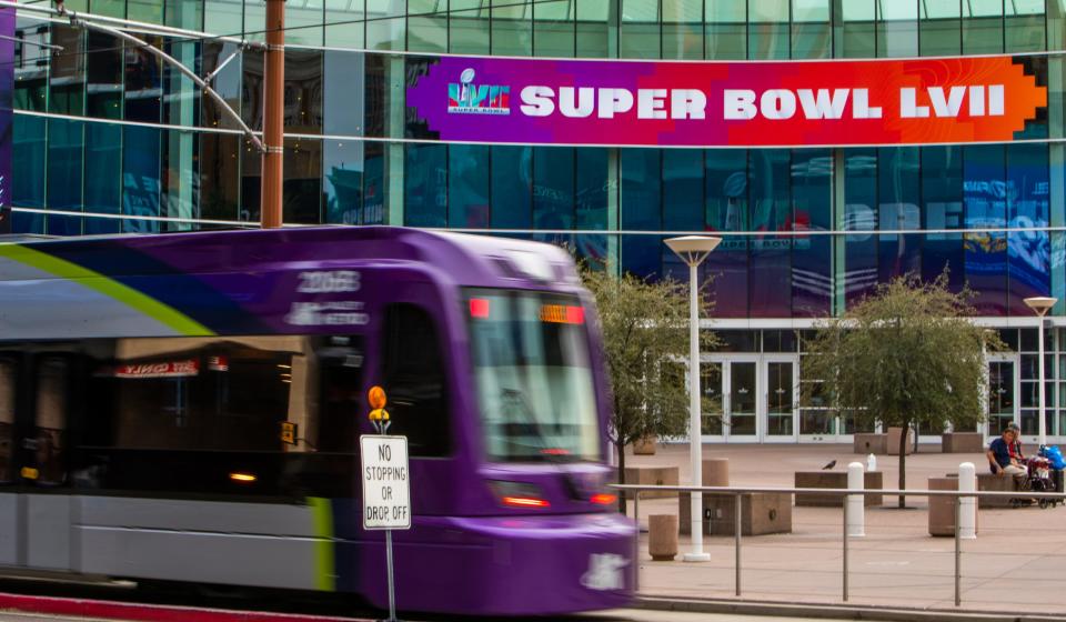 The light rail passes Super Bowl 57 signs in downtown Phoenix on Feb. 3, 2023.