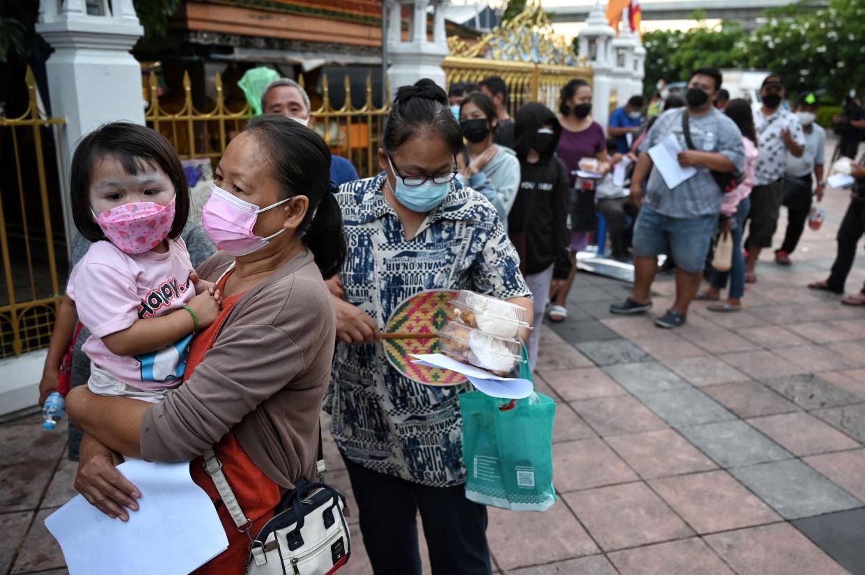 People line up to receive tickets for free Covid-19 swab testing in Bangkok