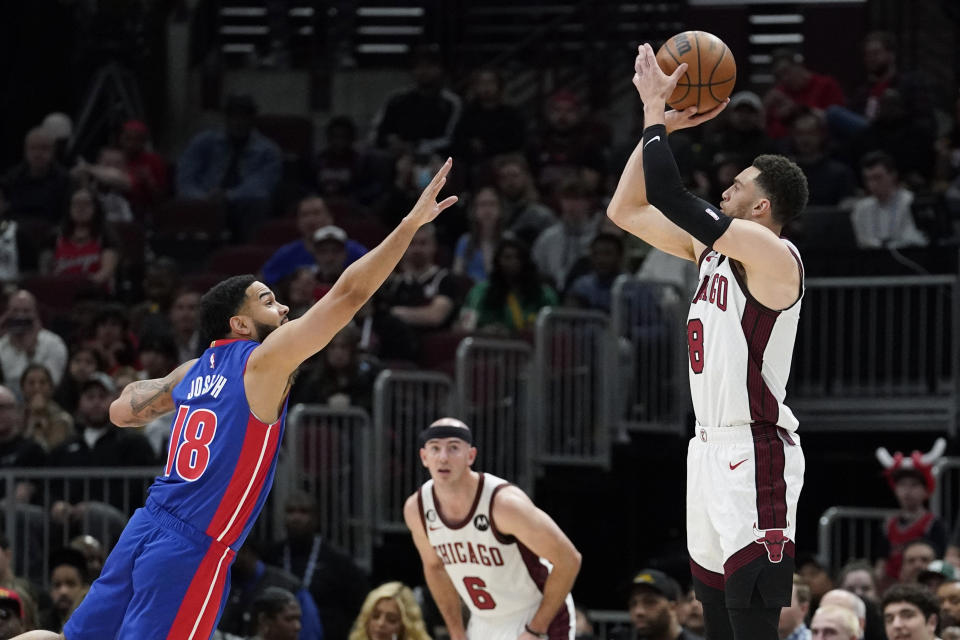 Chicago Bulls guard Zach LaVine, right, shoots against Detroit Pistons guard Cory Joseph during the first half of an NBA basketball game in Chicago, Sunday, April 9, 2023. (AP Photo/Nam Y. Huh)