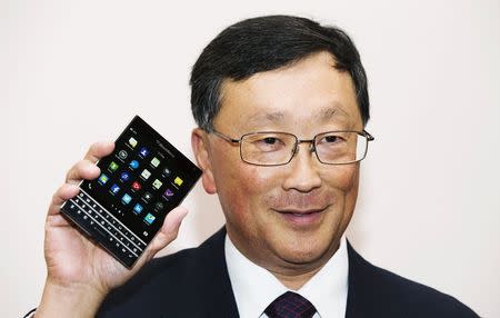 Chief Executive Officer of BlackBerry Ltd John Chen holds up the unreleased Blackberry Passport device at their annual general meeting for shareholders in Waterloo in this file photo taken June 19, 2014. BlackBerry is set to announce the acquisition of a German firm focused on voice and data encryption, burnishing its image in the eyes of ultra security conscious clients like government agencies. REUTERS/Mark Blinch/Files (CANADA - Tags: BUSINESS TELECOMS)