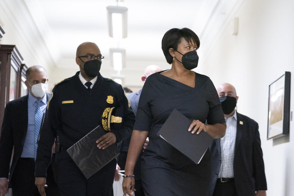 FILE - Washington Mayor Muriel Bowser, center-right, walks with Washington Metropolitan Police Chief Robert Contee III, center-left, before a news conference on Feb. 28, 2022, in Washington. For years, liberal cities in the U.S have tolerated people living in tents in parks and public spaces, but increasingly leaders in places like Portland, Oregon, New York, Seattle and other cities are removing encampments and pushing other strict measures that would've been unheard of a few years ago. In the summer of 2021, Bowser launched a pilot program to permanently clear several homeless encampments. (AP Photo/Alex Brandon, File)