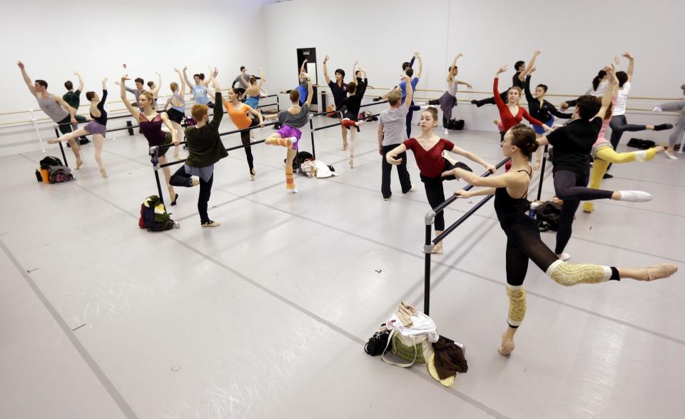 In this Wednesday, Feb. 27, 2013 photo, Pennsylvania Ballet's dancers perform exercises during a class at their new facility in Philadelphia. The company is celebrating its 50th birthday with a new facility and a season of performing brand new works and classic pieces. (AP Photo/Matt Rourke)