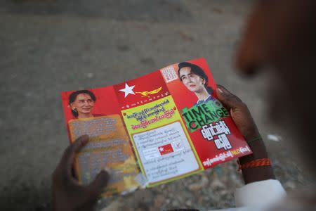 A man reads National League for Democracy (NLD) party campaign pamphlet during a NLD party campaign rally in Yangon November 5, 2015. REUTERS/Soe Zeya Tun