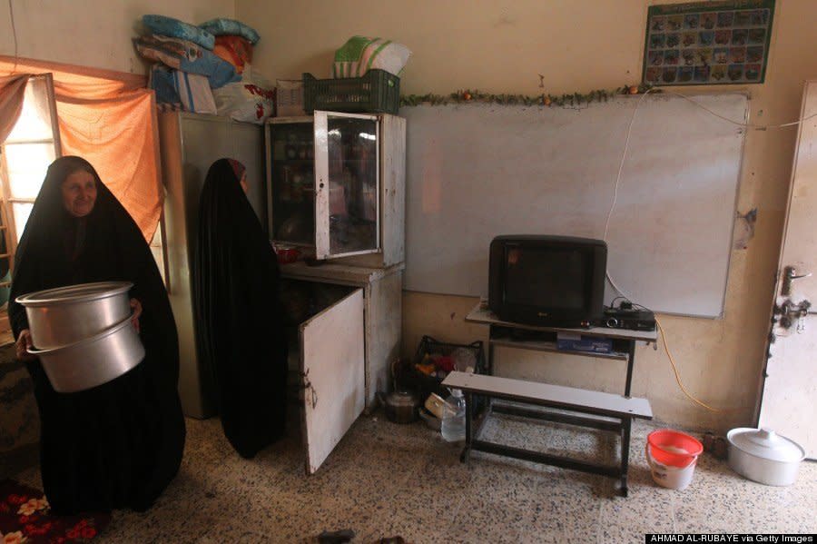 Iraqi Turkman Shiite women, displaced from the northern Iraqi area of Tal Afar, take shelter in a school in Sadr City, one of Baghdad's northern Shiite-majority districts, on August 5, 2014. (AHMAD AL-RUBAYE/AFP/Getty Images) 