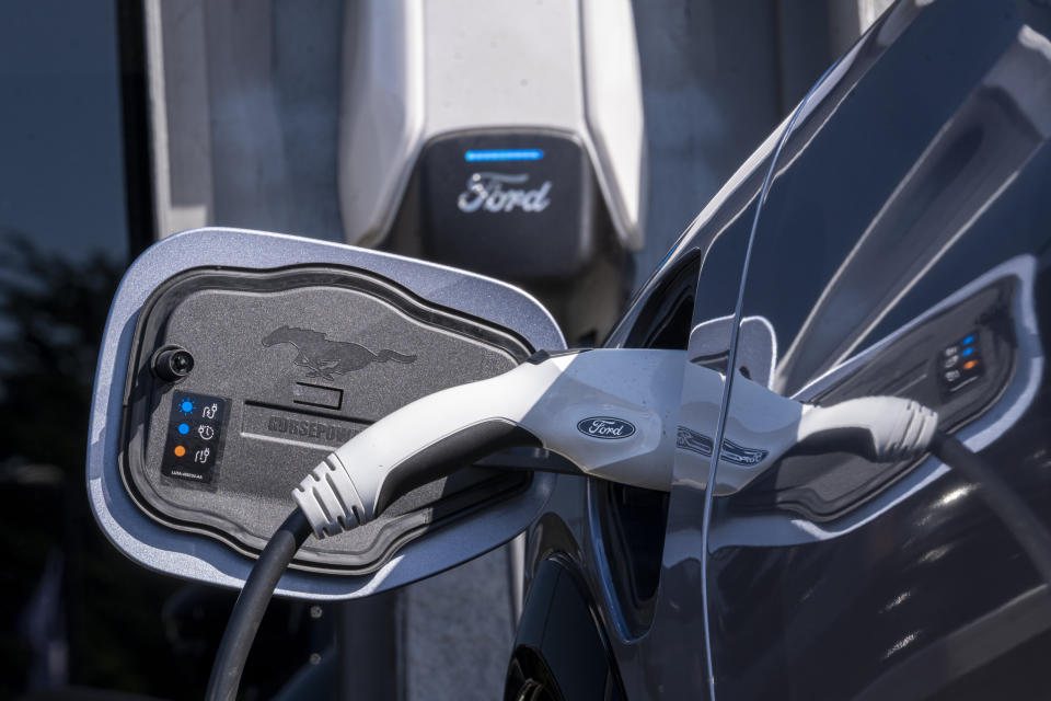 A Ford electrical power charger plugged into a Mustang Mach-E.