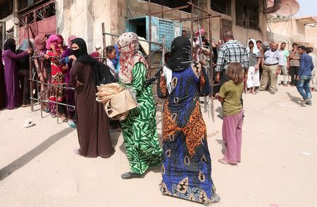 People queue for bread in the northeastern city of Hasaka, Syria, August 21, 2016. REUTERS/Rodi Said