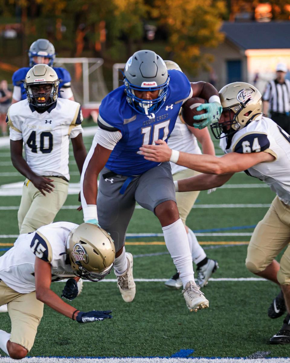 Fernando Marquez (10) splits Comet defenders Quinn Poole (15) and Wyatt Kauffman (64) scoring a TD. The Cedar Crest Falcons played host to the Penn Manor Comets on Friday, Sept. 15, 2023. The Falcons defeated the Comets, 42-13, to improve to 4-0.