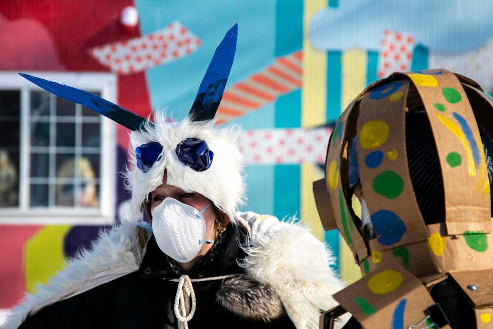 Zoe Webb, left, talks with Ivan Santana as the two are dressed as a leopard moth and octopus, respectively, during the Iowa City Joy March, Saturday, Jan. 15, 2022, in Iowa City, Iowa.