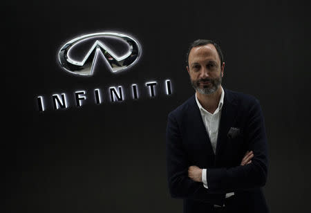 Infiniti, Nissan Motor's premium brand, Executive Design Director Karim Habib poses for a photo in front of the Infiniti logo at its Global Design Center in Atsugi, Japan, April 18, 2018. Picture taken April 18, 2018. REUTERS/Toru Hanai