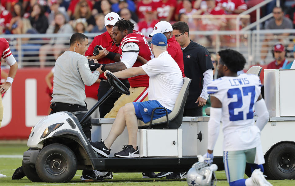 San Francisco 49ers offensive tackle Shon Coleman, center left, is helped onto a cart during the first half of the team's NFL preseason football game against the Dallas Cowboys in Santa Clara, Calif., Saturday, Aug. 10, 2019. (AP Photo/Josie Lepe)